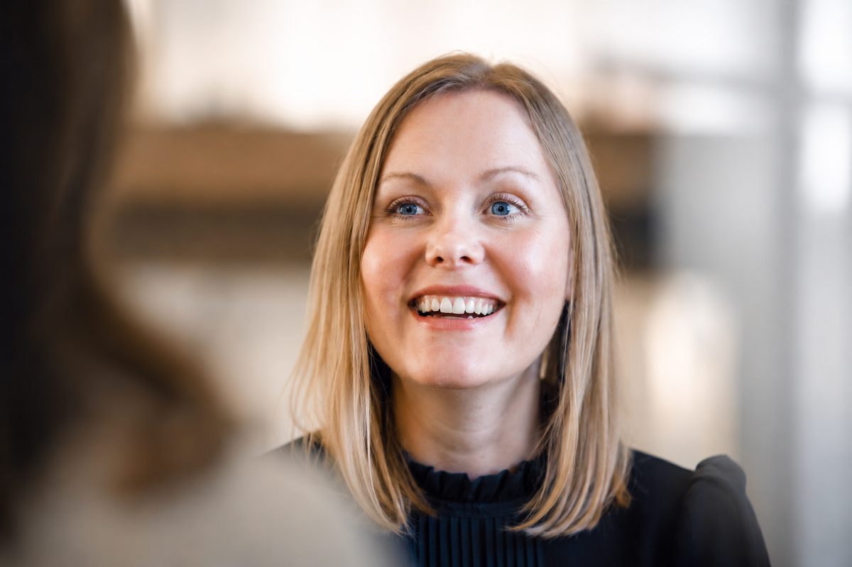 A team member smiling mid-conversation